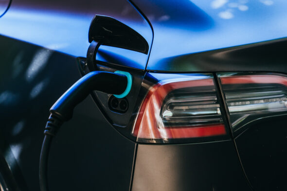 Cropped image of electric car charging. Future, new technologies. Ecological solutions. Effici...